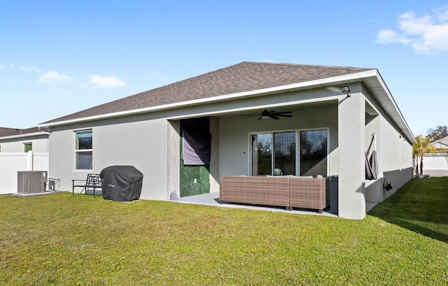 back of house featuring ceiling fan, an outdoor hangout area, central AC unit, and a lawn