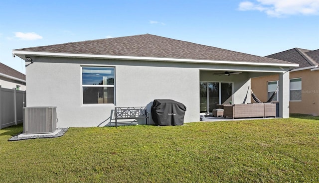 rear view of house with central AC unit, a yard, an outdoor hangout area, and ceiling fan