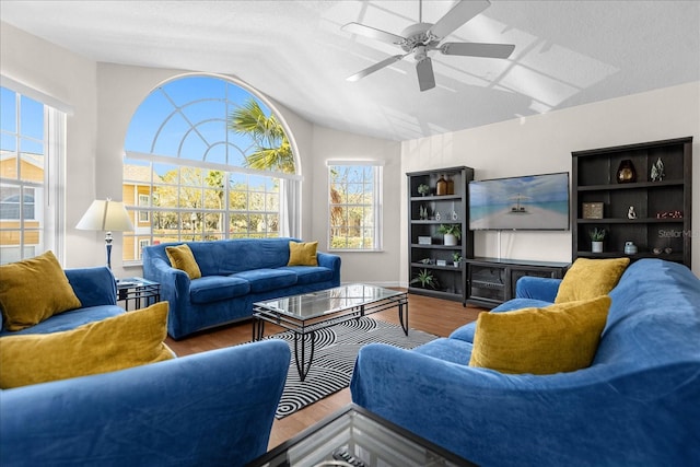 living room with vaulted ceiling, hardwood / wood-style floors, and ceiling fan