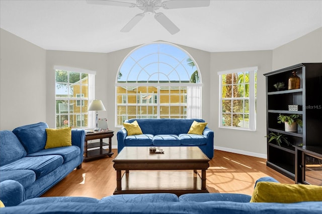 living room featuring hardwood / wood-style flooring, vaulted ceiling, a wealth of natural light, and ceiling fan