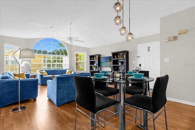 dining area featuring lofted ceiling, hardwood / wood-style floors, and ceiling fan