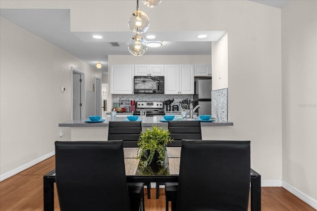 dining area featuring hardwood / wood-style floors