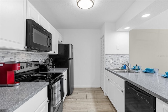 kitchen with sink, black appliances, a textured ceiling, decorative backsplash, and white cabinets