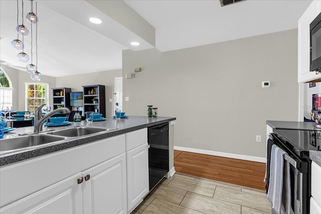 kitchen featuring sink, decorative light fixtures, black appliances, light wood-type flooring, and white cabinets