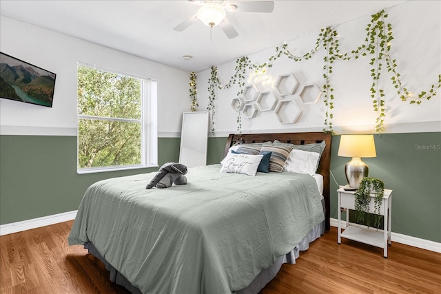 bedroom featuring wood-type flooring and ceiling fan