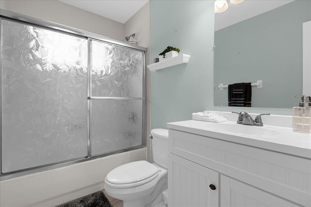 full bathroom with vanity, enclosed tub / shower combo, and toilet