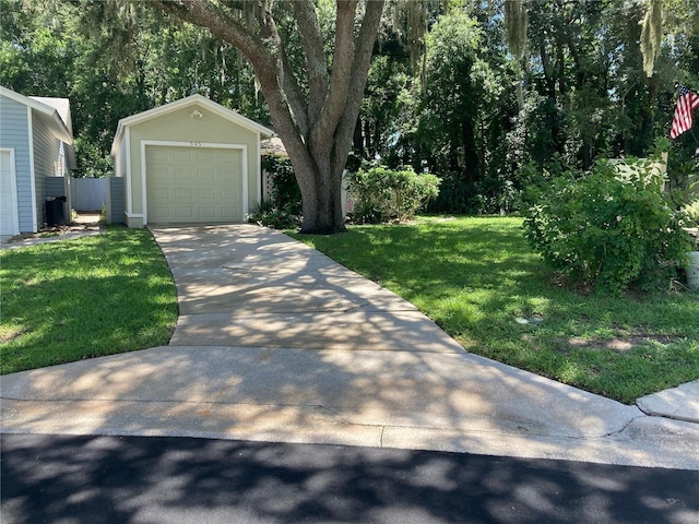 view of yard with a garage and an outbuilding