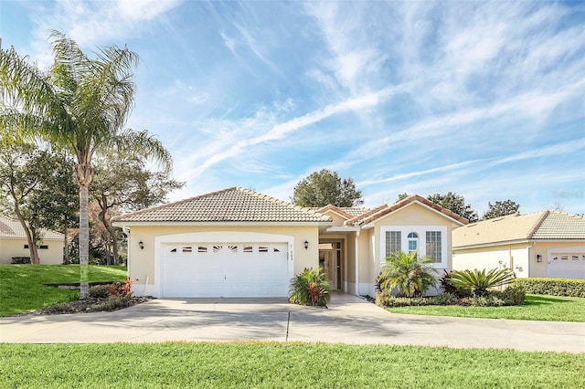 view of front of house with a garage and a front lawn