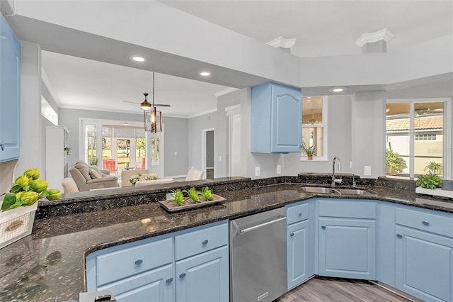 kitchen featuring a healthy amount of sunlight, sink, ornamental molding, stainless steel dishwasher, and blue cabinetry