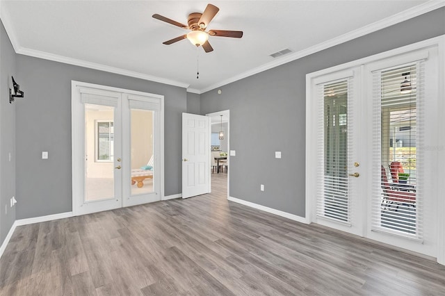 interior space featuring multiple windows, light hardwood / wood-style flooring, access to outside, and french doors