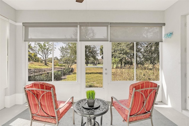 sunroom / solarium with a wealth of natural light and ceiling fan