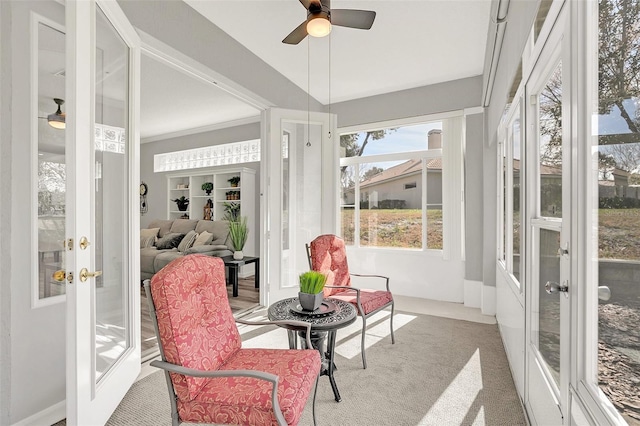 sunroom / solarium featuring french doors and ceiling fan