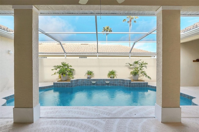 view of pool featuring a lanai and ceiling fan