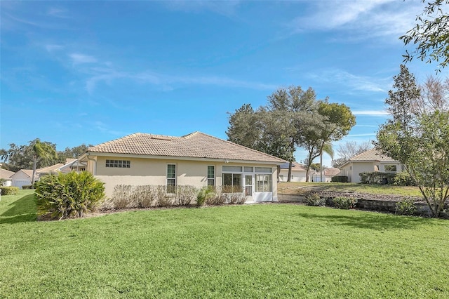 rear view of house with a lawn