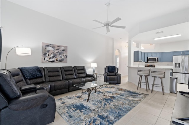 tiled living room featuring sink and ceiling fan