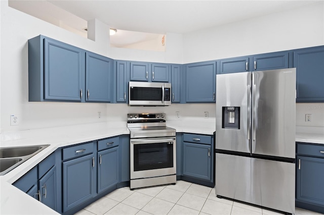 kitchen with blue cabinetry and stainless steel appliances