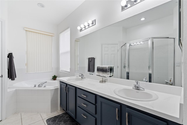 bathroom featuring tile patterned floors, shower with separate bathtub, and vanity