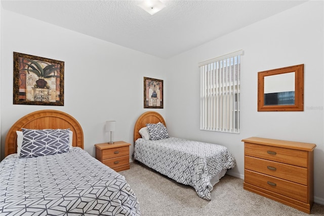 bedroom with light carpet and a textured ceiling