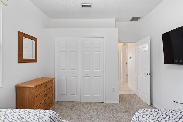 carpeted bedroom featuring a closet