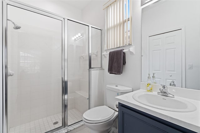 bathroom featuring vanity, toilet, and an enclosed shower