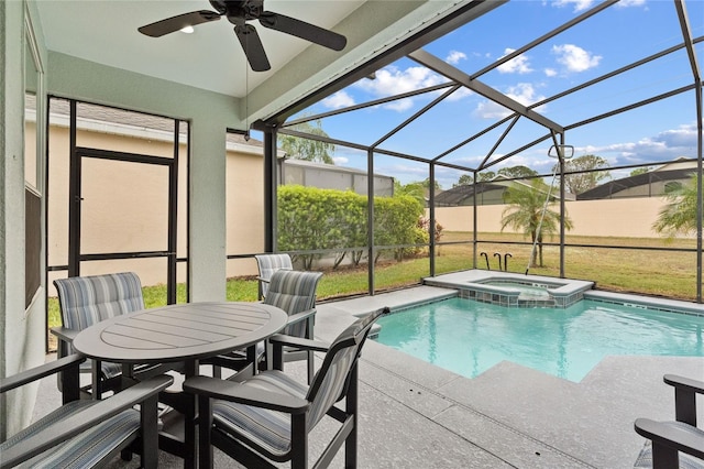 view of swimming pool featuring an in ground hot tub, a lanai, a lawn, and a patio area