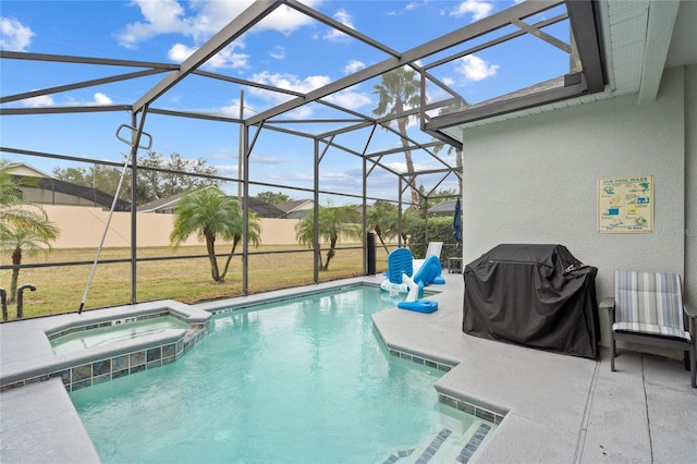 view of pool with area for grilling, glass enclosure, a lawn, an in ground hot tub, and a patio