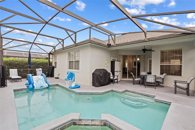 view of swimming pool with grilling area, a lanai, an in ground hot tub, ceiling fan, and a patio