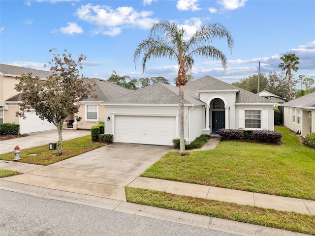 single story home with a garage and a front lawn