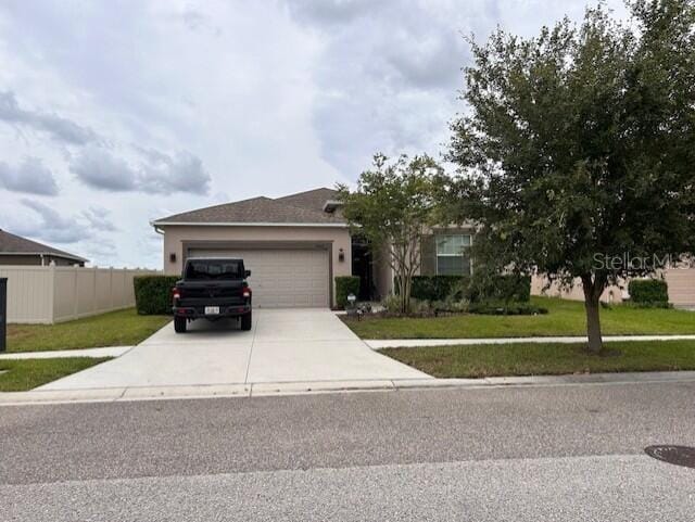 view of front of home featuring a garage and a front yard