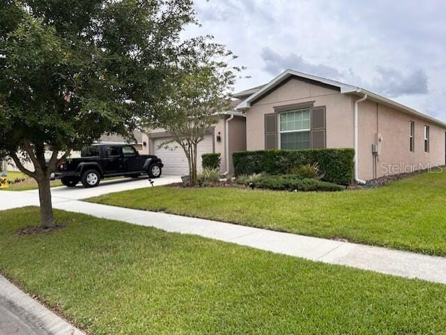 ranch-style house with a garage and a front yard