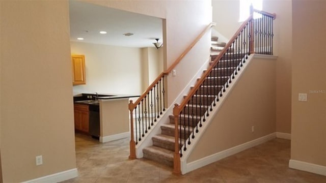 stairway with tile patterned flooring, a high ceiling, baseboards, and recessed lighting