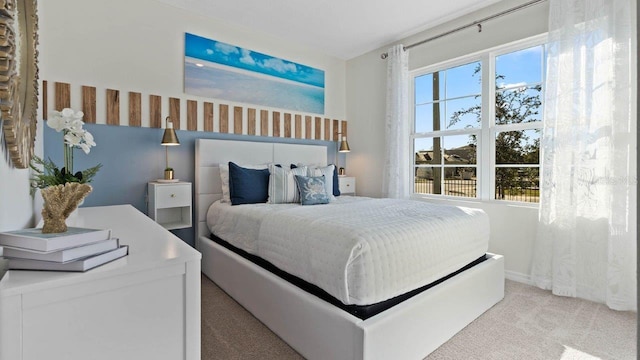 bedroom with multiple windows and light colored carpet