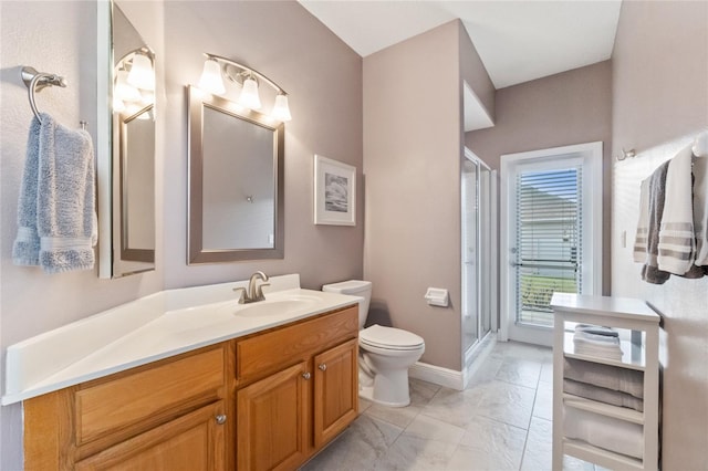 bathroom with vanity, a shower with shower door, and toilet