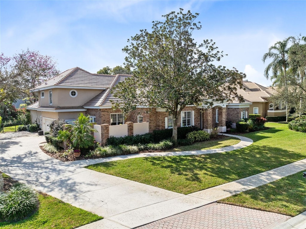 view of front of property with a garage and a front yard