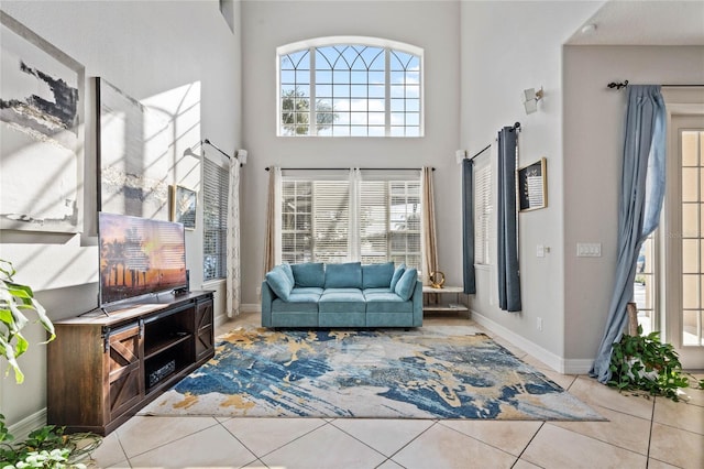 interior space featuring light tile patterned floors and a high ceiling