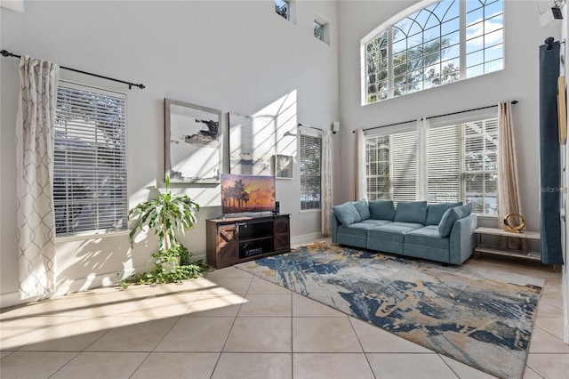 tiled living room featuring a high ceiling