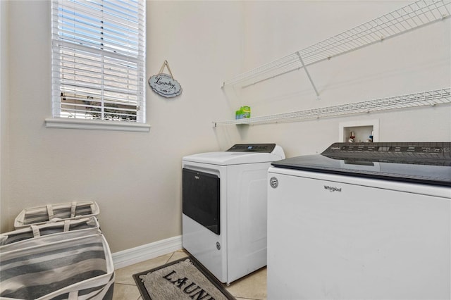 washroom featuring separate washer and dryer and light tile patterned floors