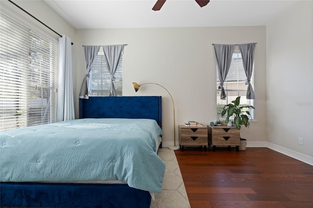 bedroom with ceiling fan and dark hardwood / wood-style flooring