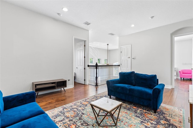 living room featuring hardwood / wood-style floors and a textured ceiling