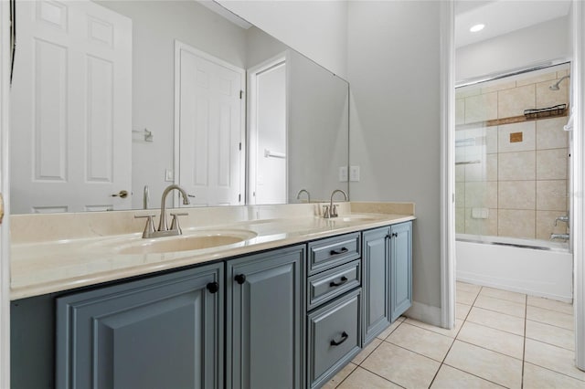 bathroom with tile patterned floors, tiled shower / bath combo, and vanity