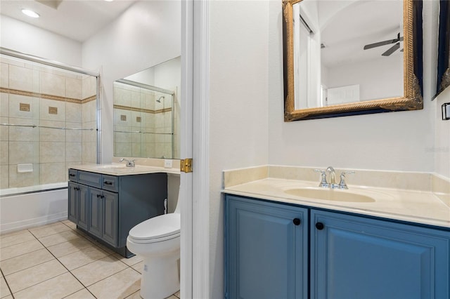 full bathroom featuring toilet, vanity, ceiling fan, tile patterned flooring, and enclosed tub / shower combo