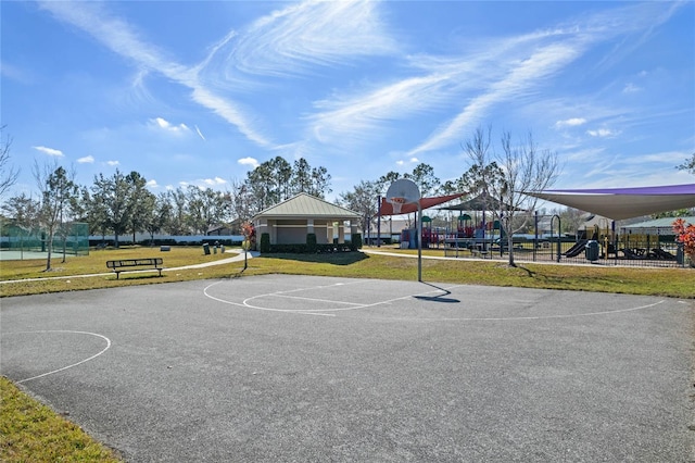 view of sport court featuring a yard and a playground