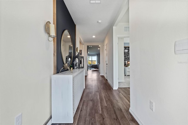 corridor featuring dark hardwood / wood-style flooring