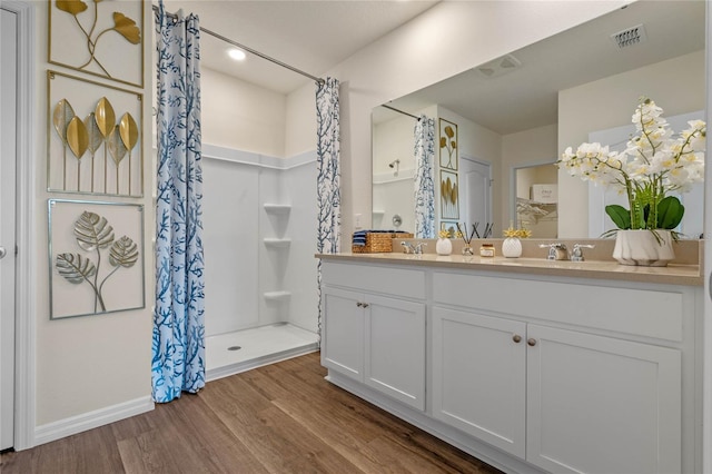 bathroom with vanity, hardwood / wood-style flooring, and walk in shower