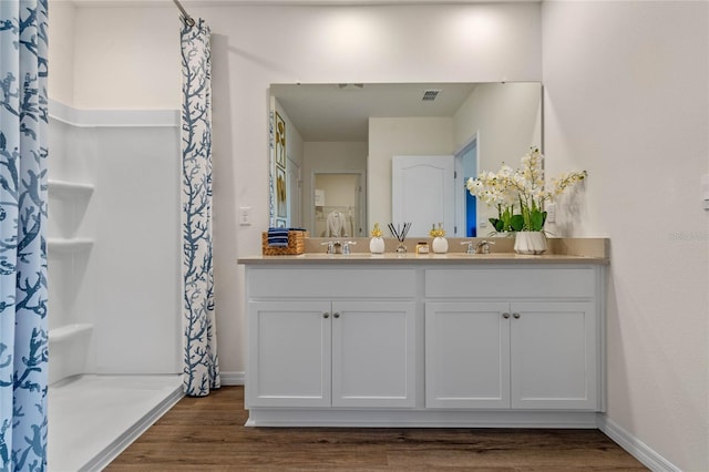 bathroom with vanity, a shower with curtain, and wood-type flooring