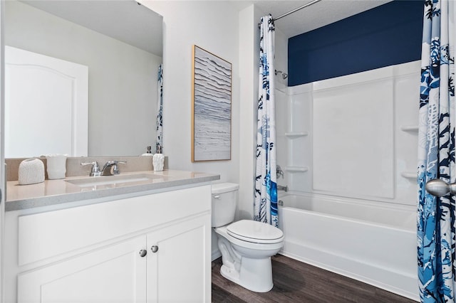 full bathroom with shower / tub combo, vanity, wood-type flooring, a textured ceiling, and toilet