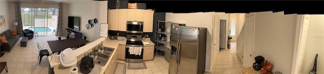 kitchen featuring white cabinetry, light tile patterned floors, sink, and appliances with stainless steel finishes