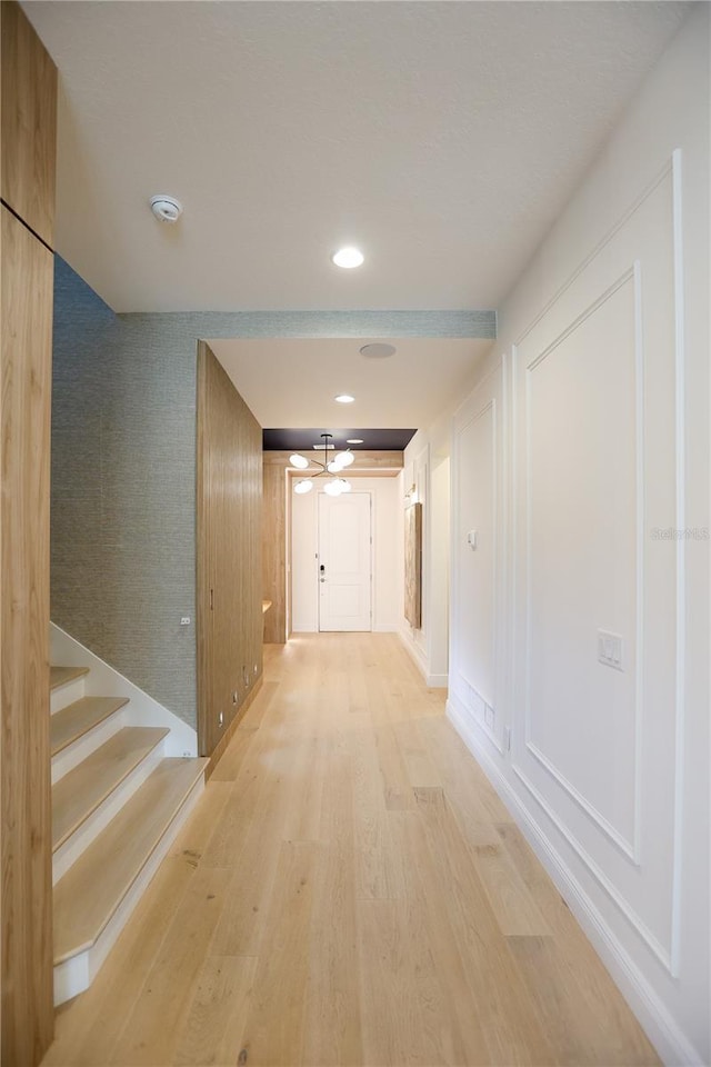 hallway with light hardwood / wood-style flooring