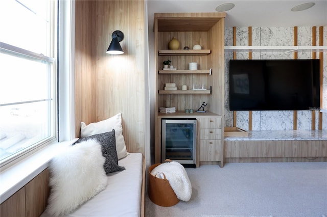 carpeted bedroom featuring wine cooler and indoor bar