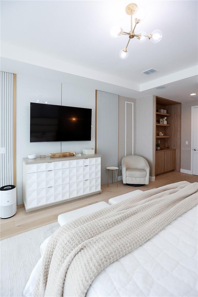 bedroom featuring wood-type flooring and a notable chandelier